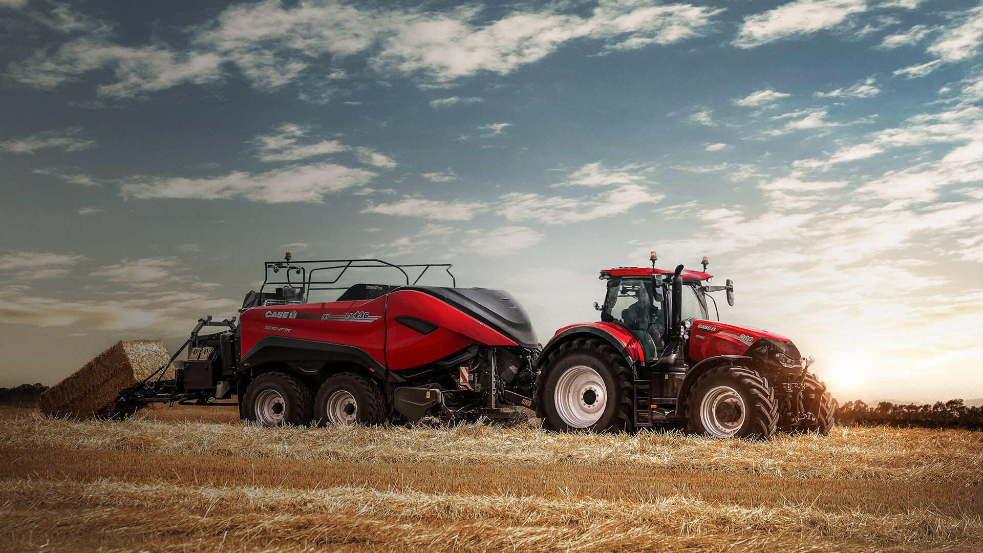 Red Case IH LB436HD baler with tractor working in field in Australian conditions