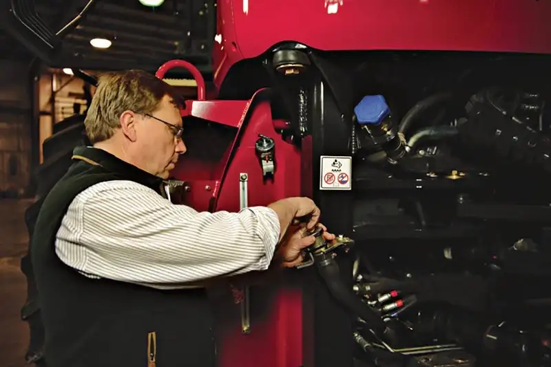 Case IH technician checking fluids