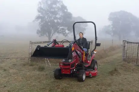 Case IH Farmall Subcompact tractor sitting in field with foggy background