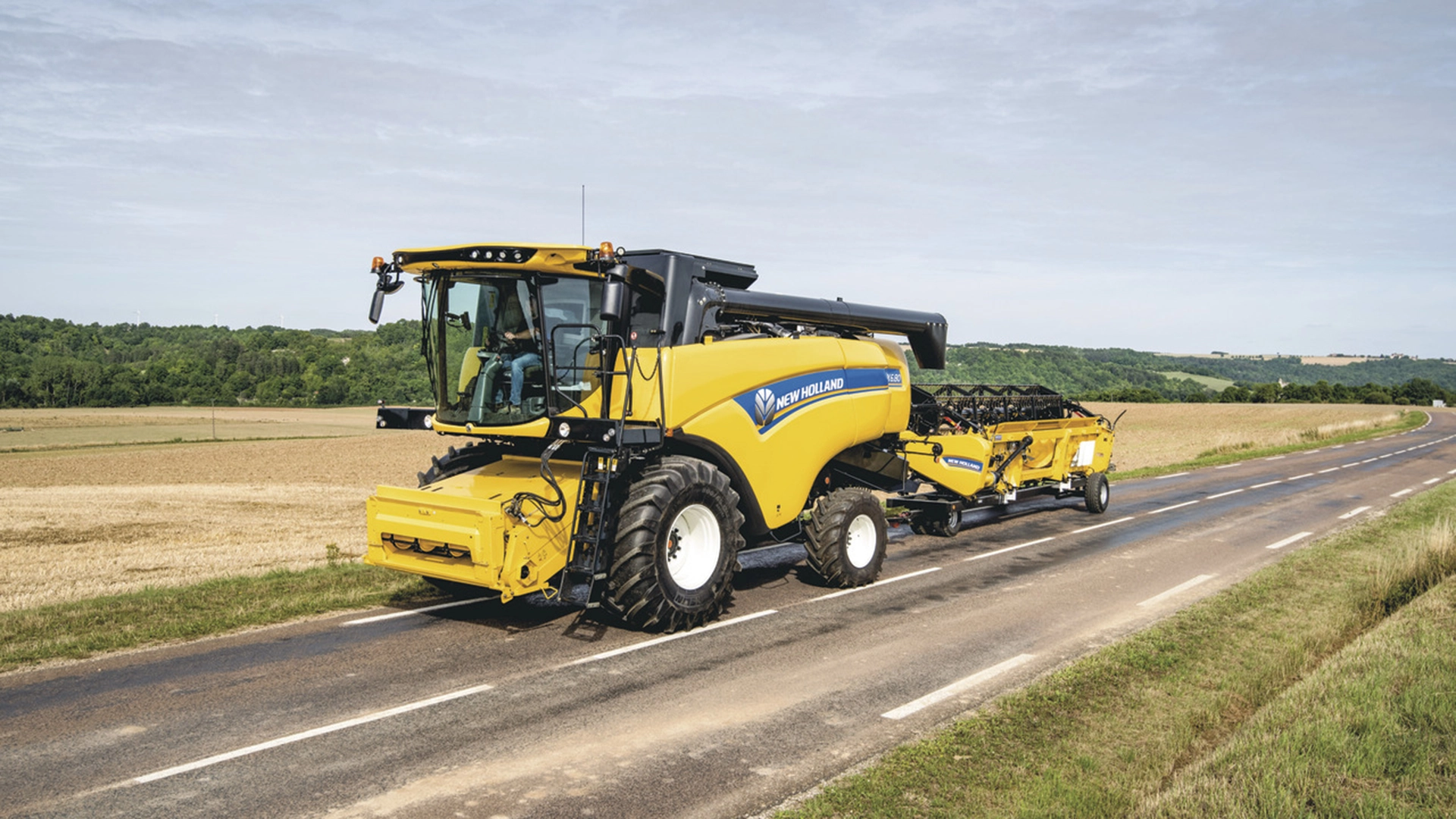 CX5-CX6 New Holland Combine harvester on the road