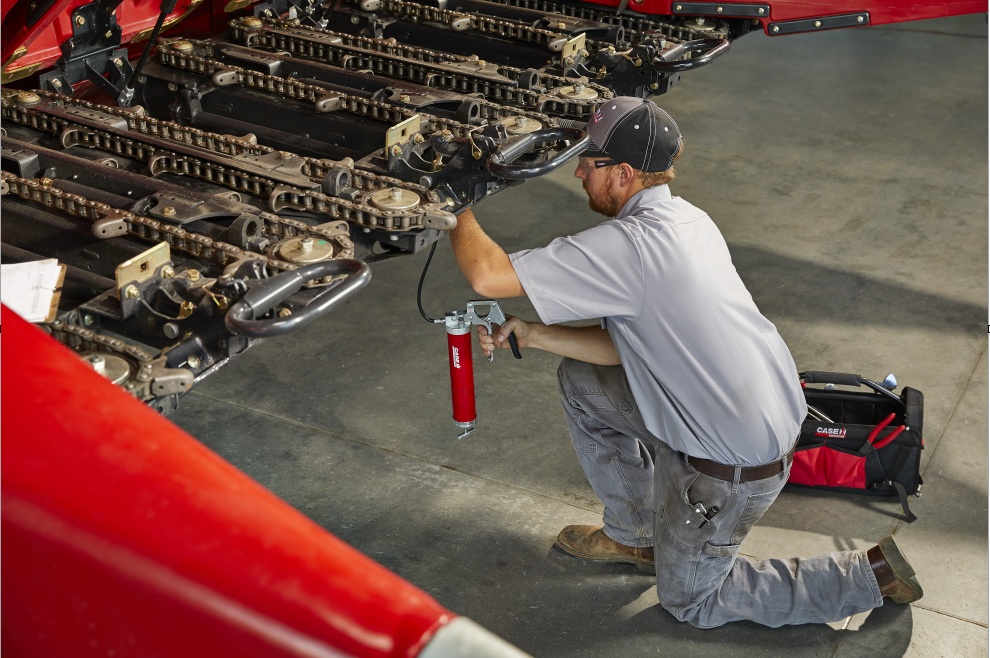 caseih technician with grease gun