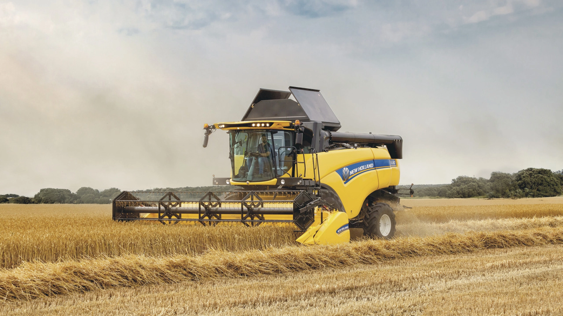 New Holland CX5-CX6 Combine Harvester in action, efficiently harvesting with agricultural combine header