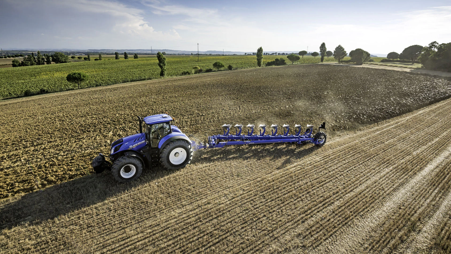 Tractor with 8 Furrow Semi-Mounted Variable Width Reversible Plough