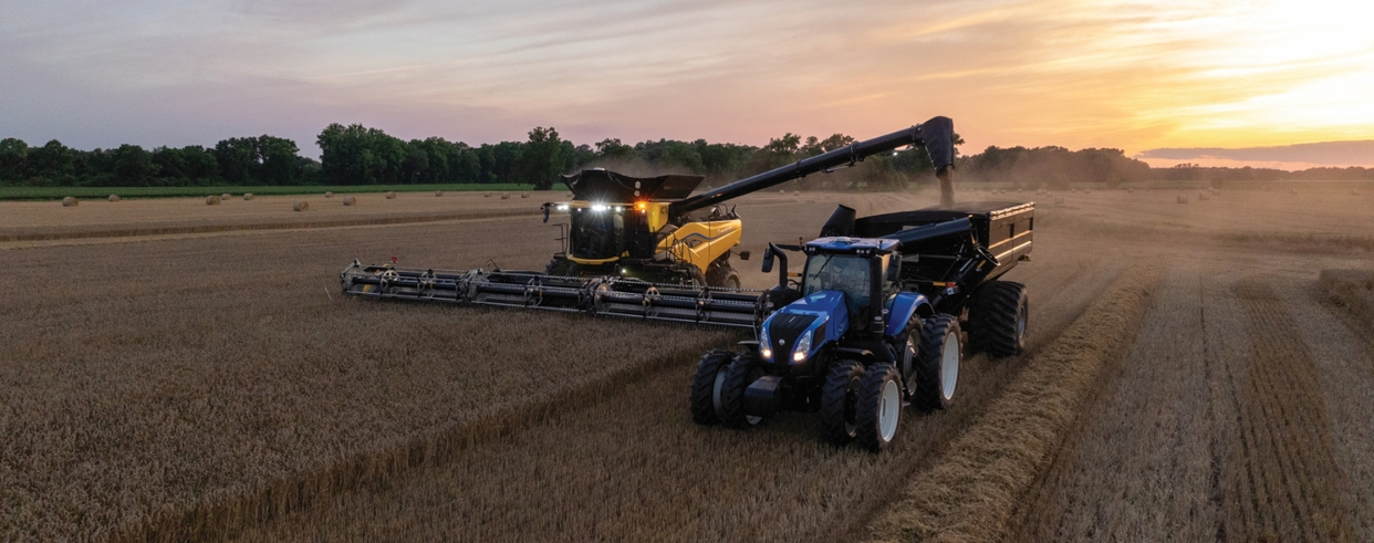 Next Generation CR Series combine in the field next to a New Holland tractor