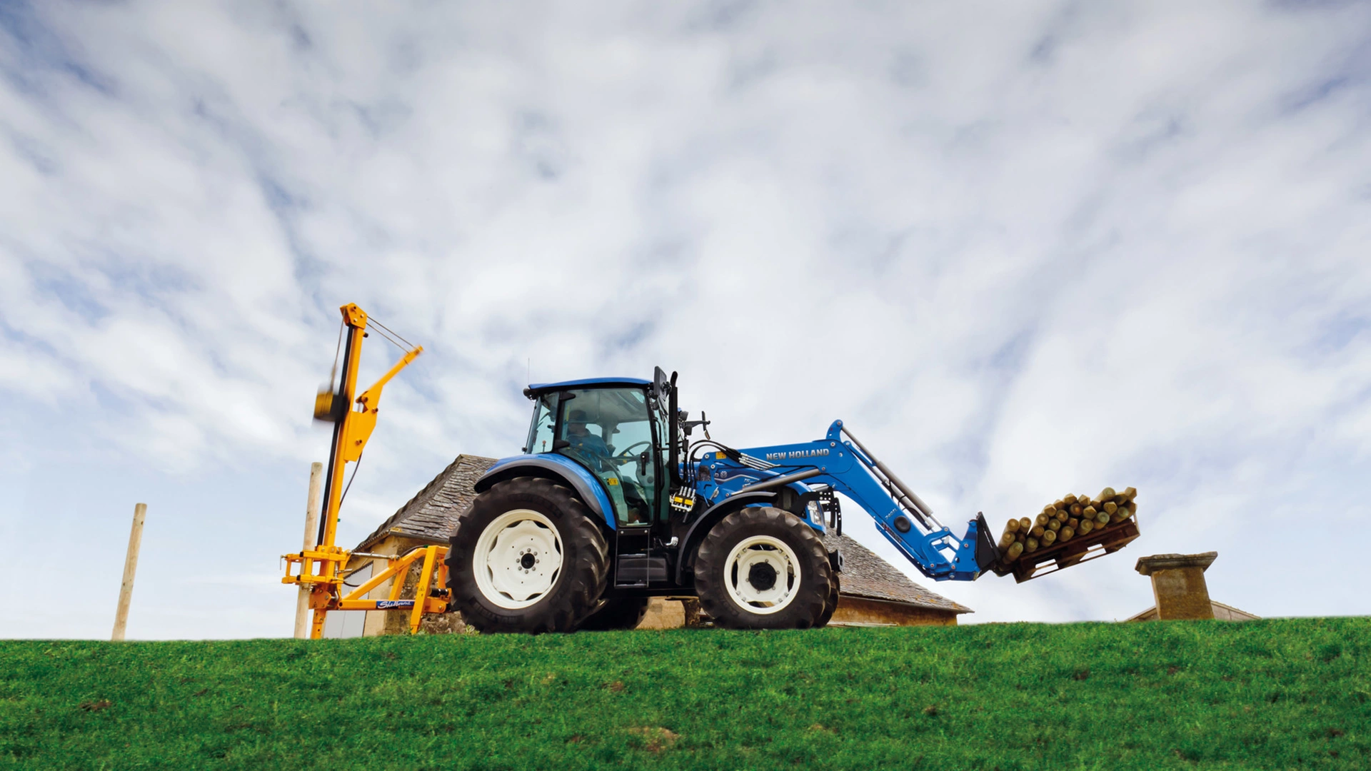 Farming tractor New Holland T5 Utility in action on agricultural land