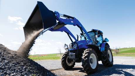 PowerStar Tractor dumping load of dirt.