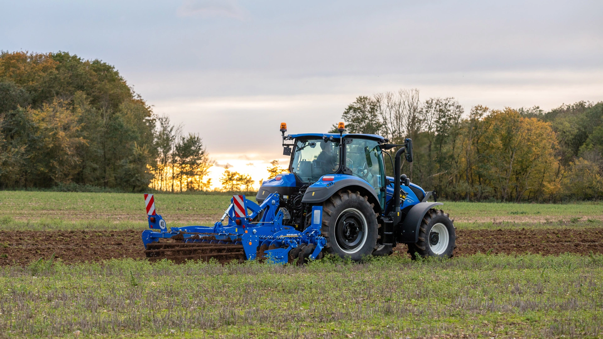 Soil preparation with SDM & SDH Disc Cultivators attached to a New Holland tractor on farmland