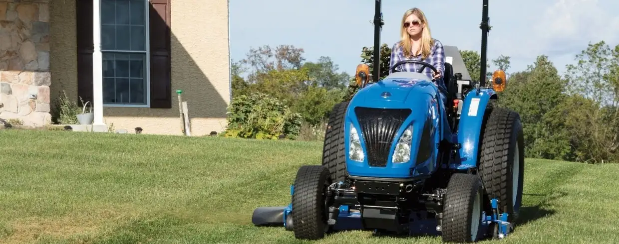 WORKMASTER tractor with mid-mount mower attachment