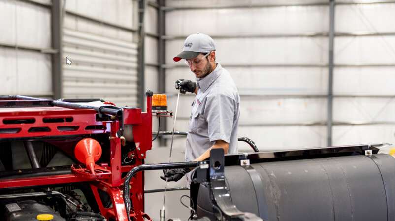 technician checking oil dipstick