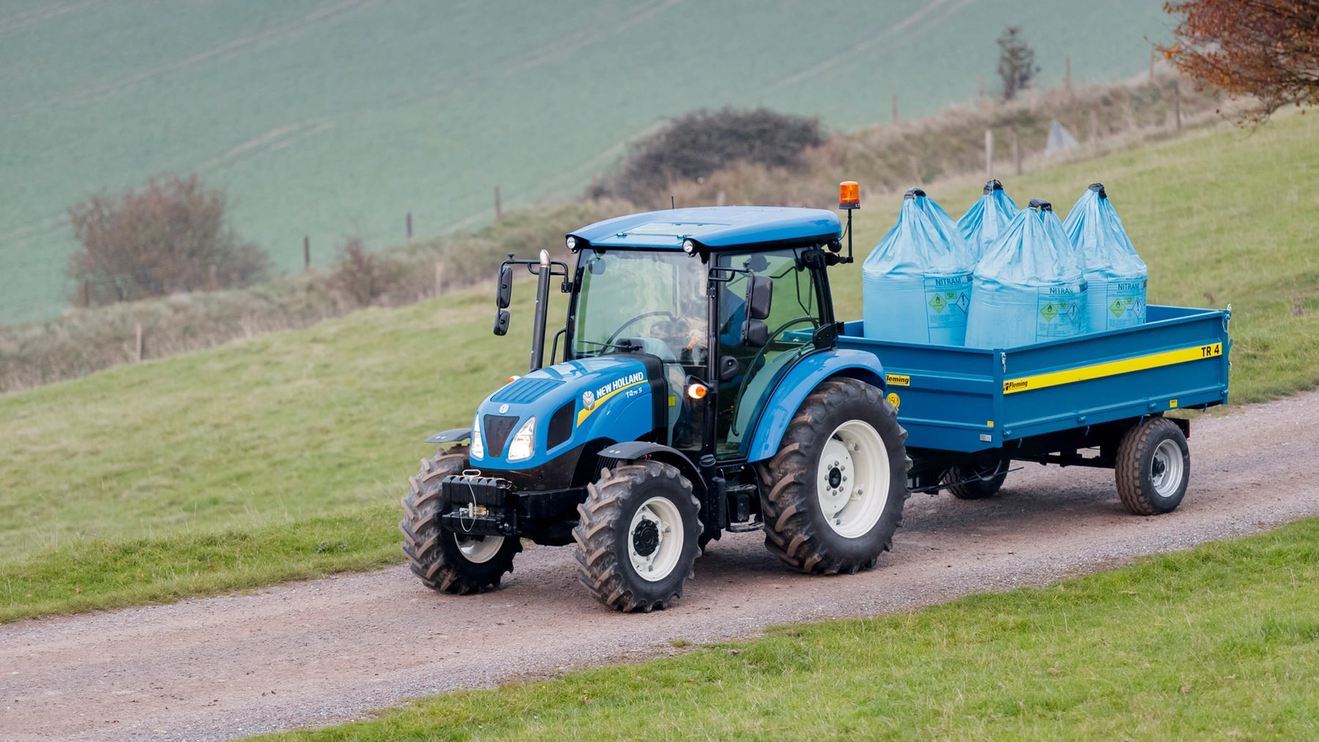 New Holland T4S agricultural tractor engaged in transportation duties