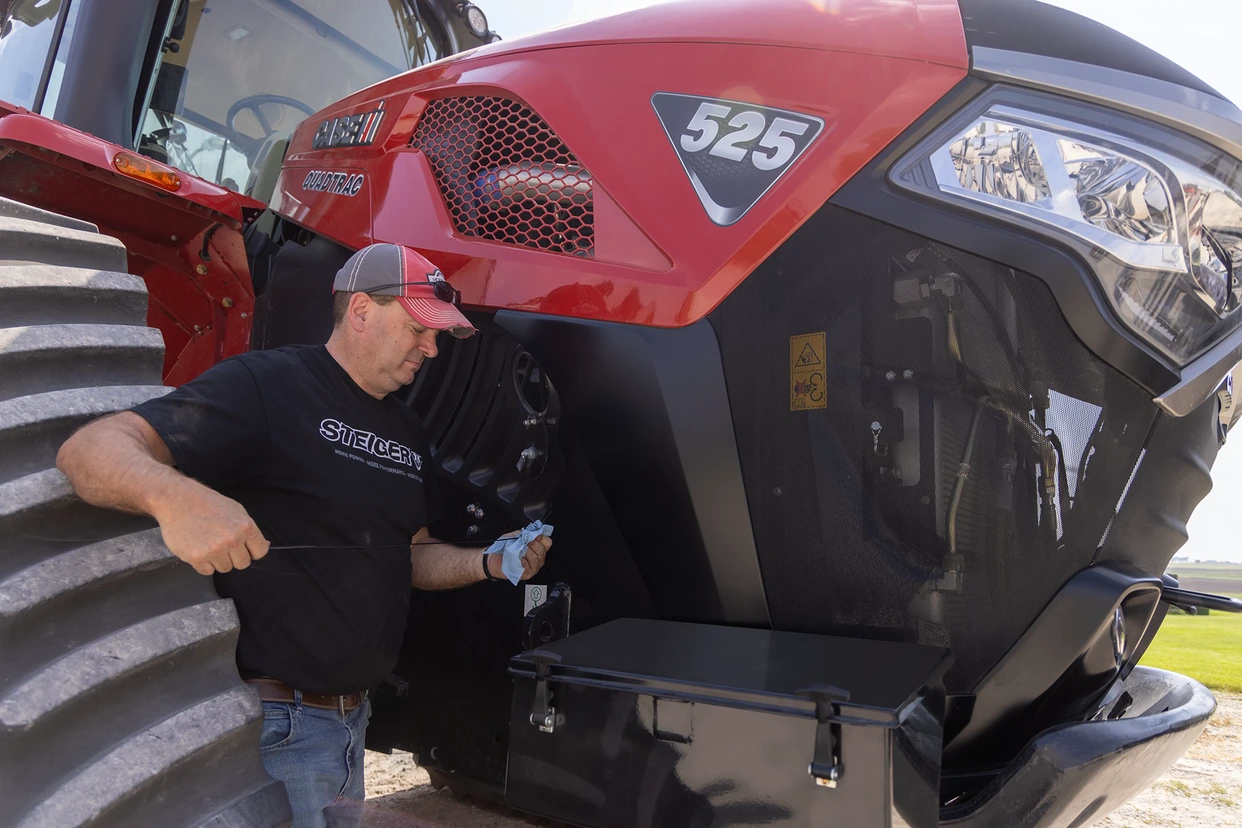 Service Person working on a Steiger 525