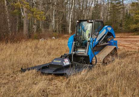 New Holland compact track loader with brush mower attachment