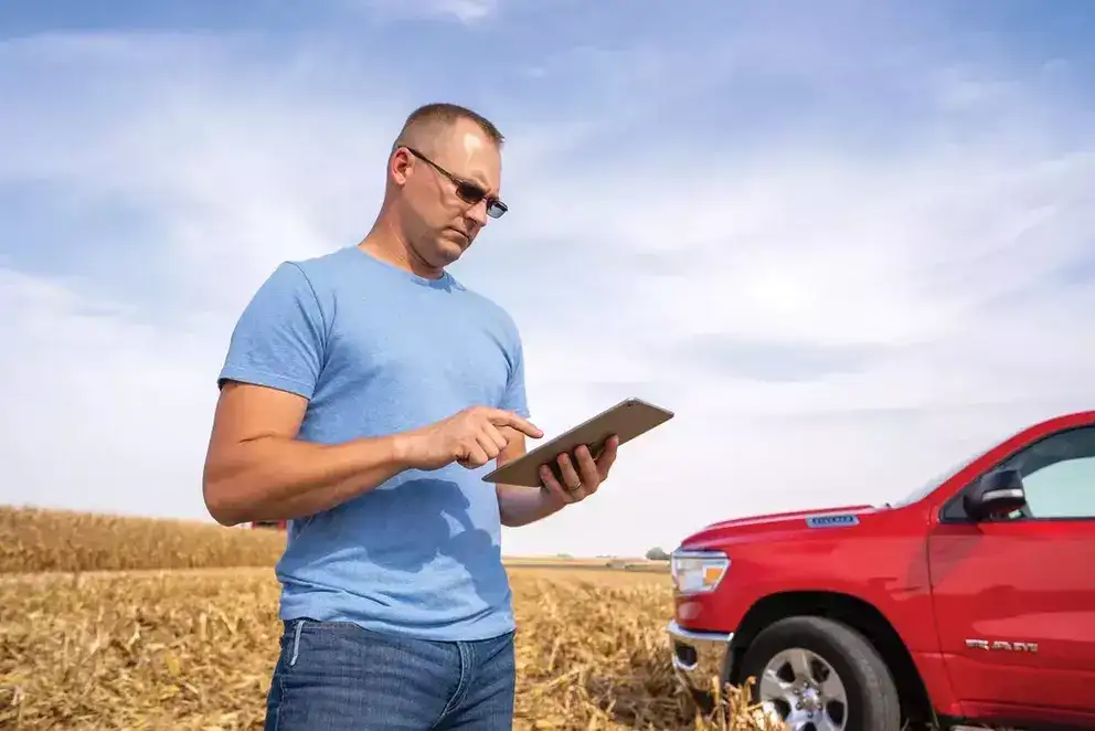 Producer in field with tablet