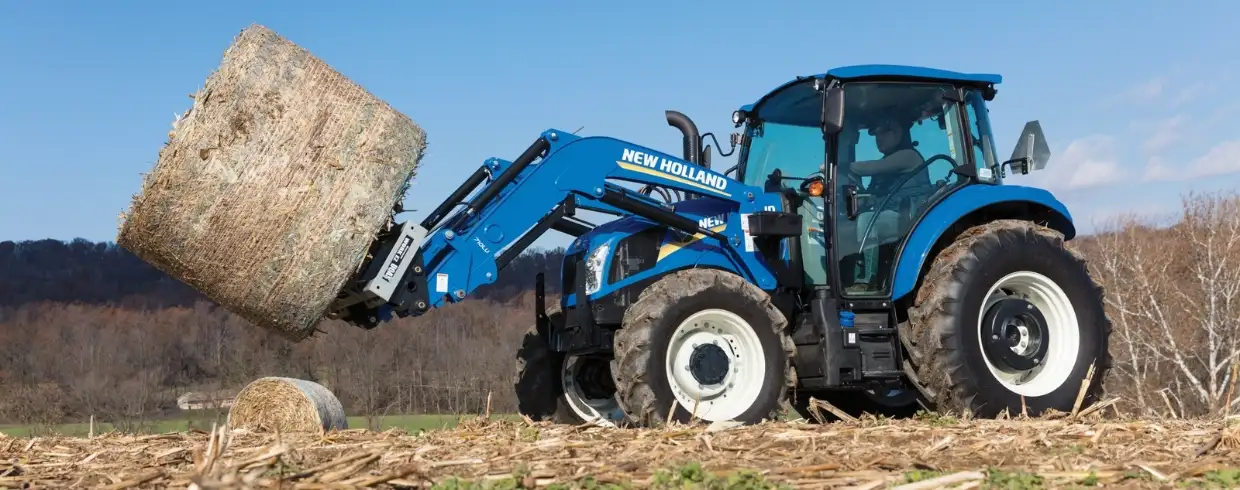 PowerStar tractor lifts a bale