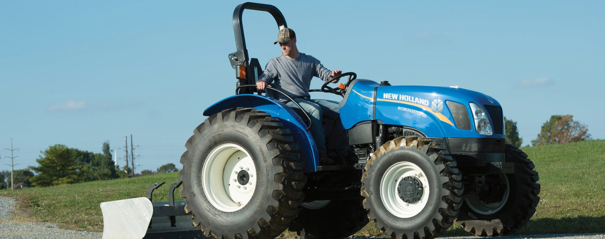 Man operates WORKMASTER tractor with a box blade attachment