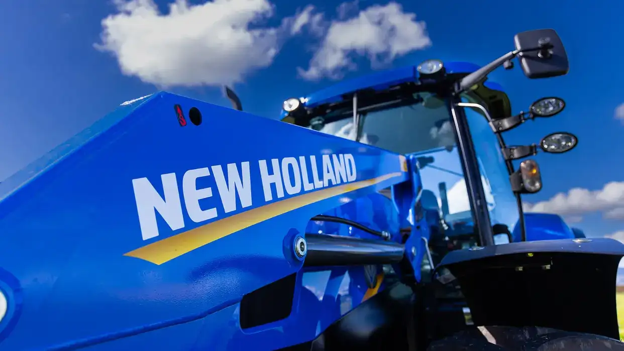New Holland T6000 Tier 3 tractor sitting in New Zealand field, with loader configuration