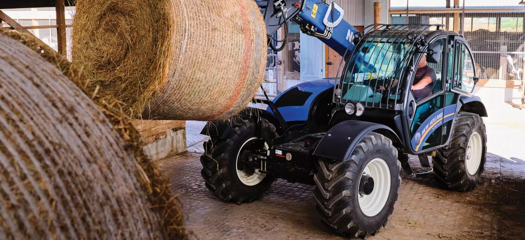 TH Series telehandler lifts a round bale