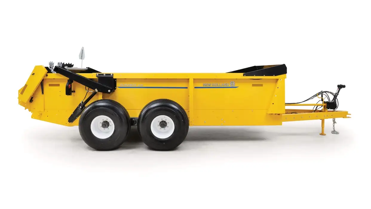 Sideview of yellow box spreader.