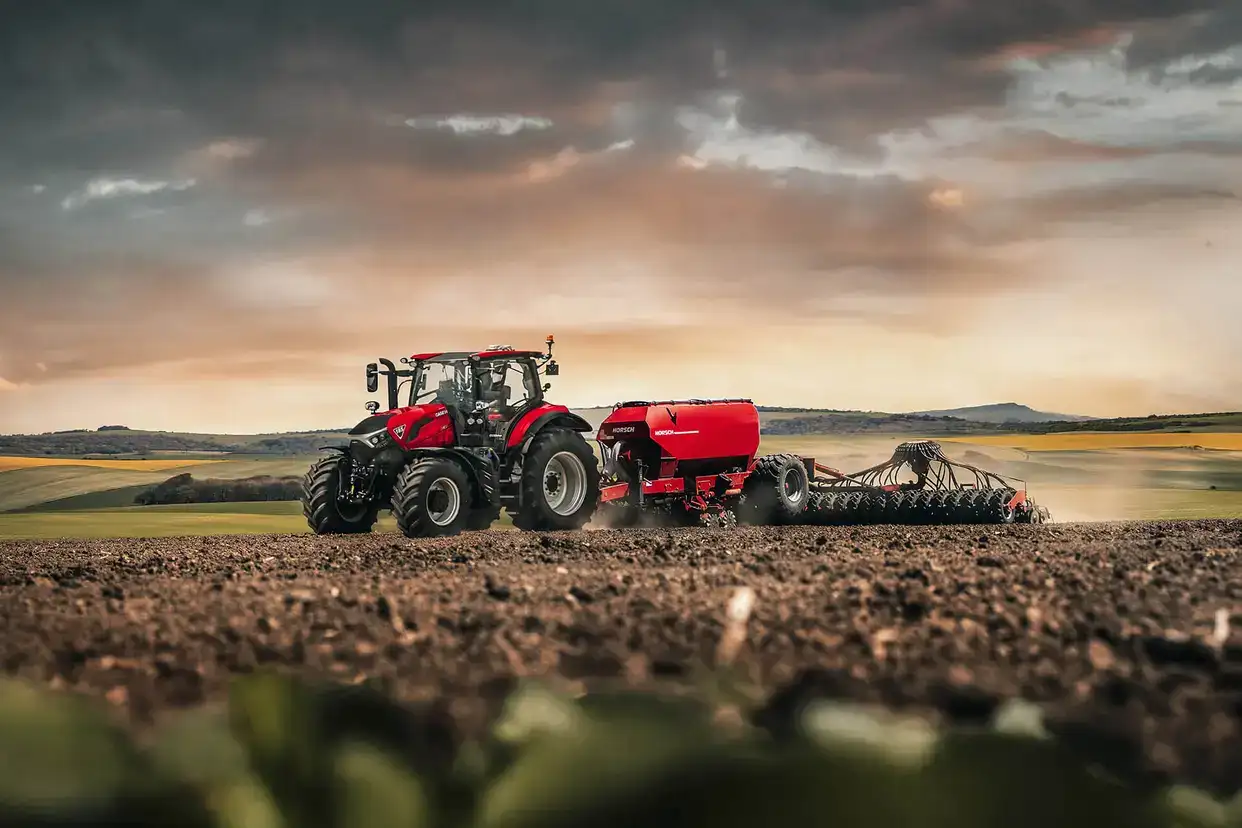 Red Case IH Puma next generation tractor sitting in field with implement attached