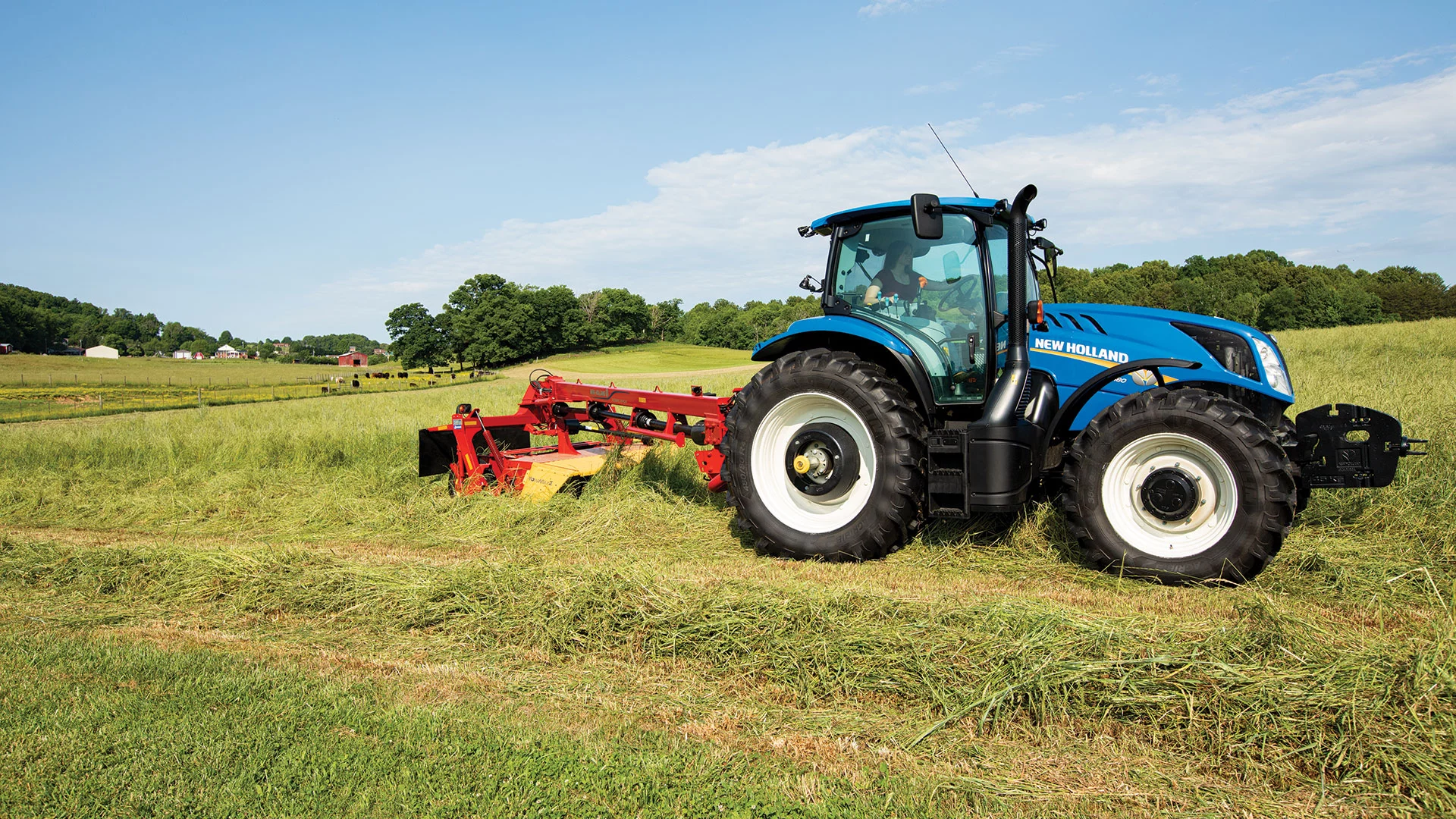 T6 Series tractor pulls a disc mower-conditioner