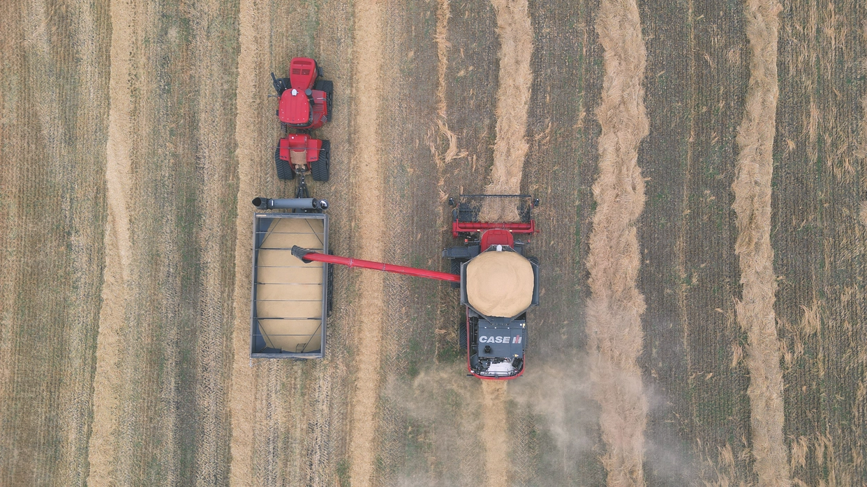 aerial view of AF11 Combine unloading into cart 