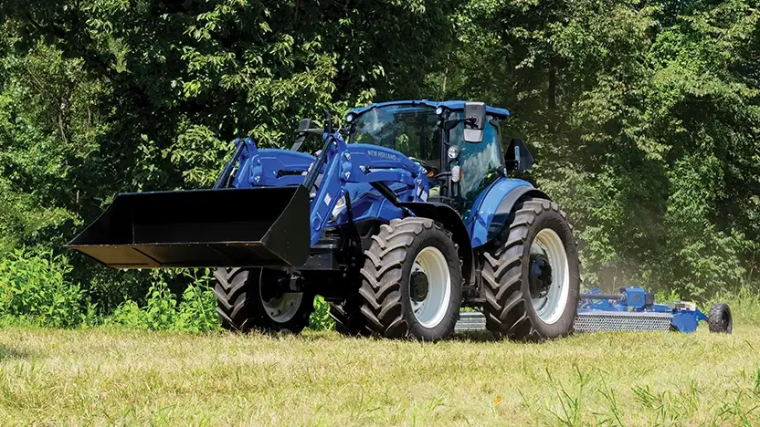 PowerStar utility tractor with bucket and pull-type rotary cutter 