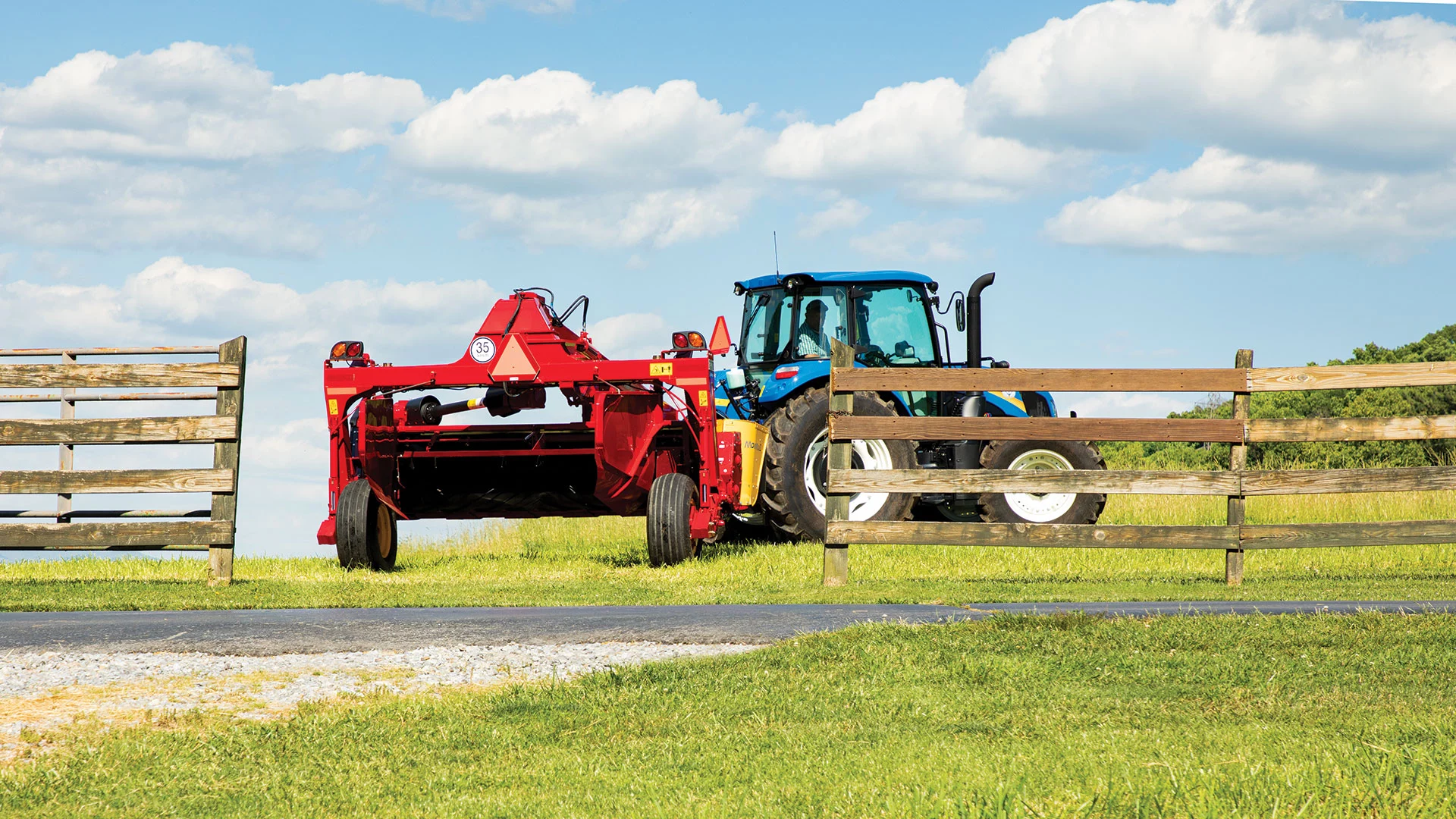 Tractor pulls a Discbine® PLUS Center-Pivot Disc Mower-Conditioner