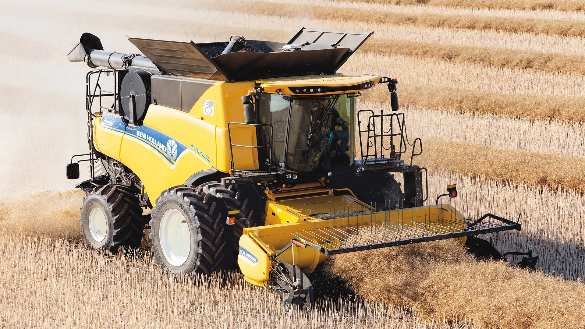 Agricultural field scene with New Holland combines utilising their Advanced Pick-Up Corn Header for optimal yield