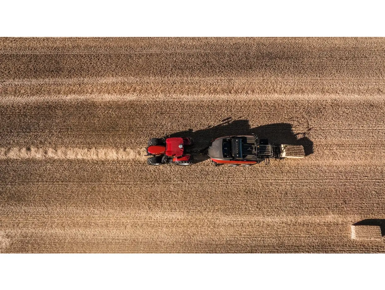 Aerial view of a Case IH tractor with LB4 XL large square baler working on a stubble field