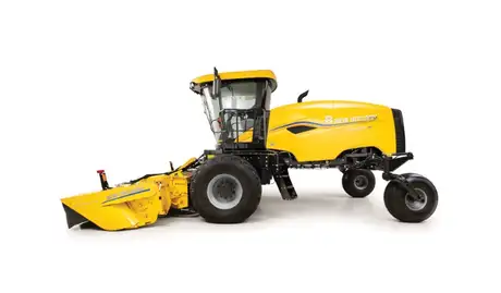 Side profile of yellow windrower.