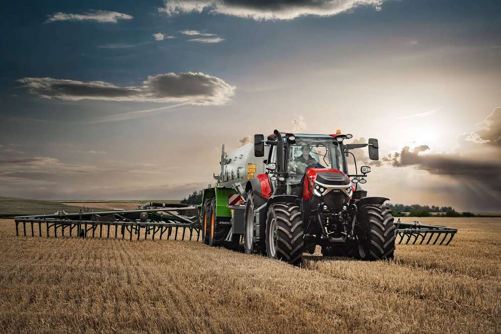 Red Case IH Puma next generation tractor sitting in field with implement attached