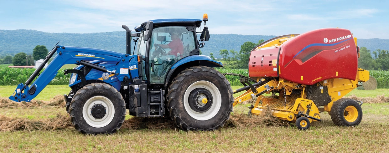 Tractor pulls a Roll-Belt round baler