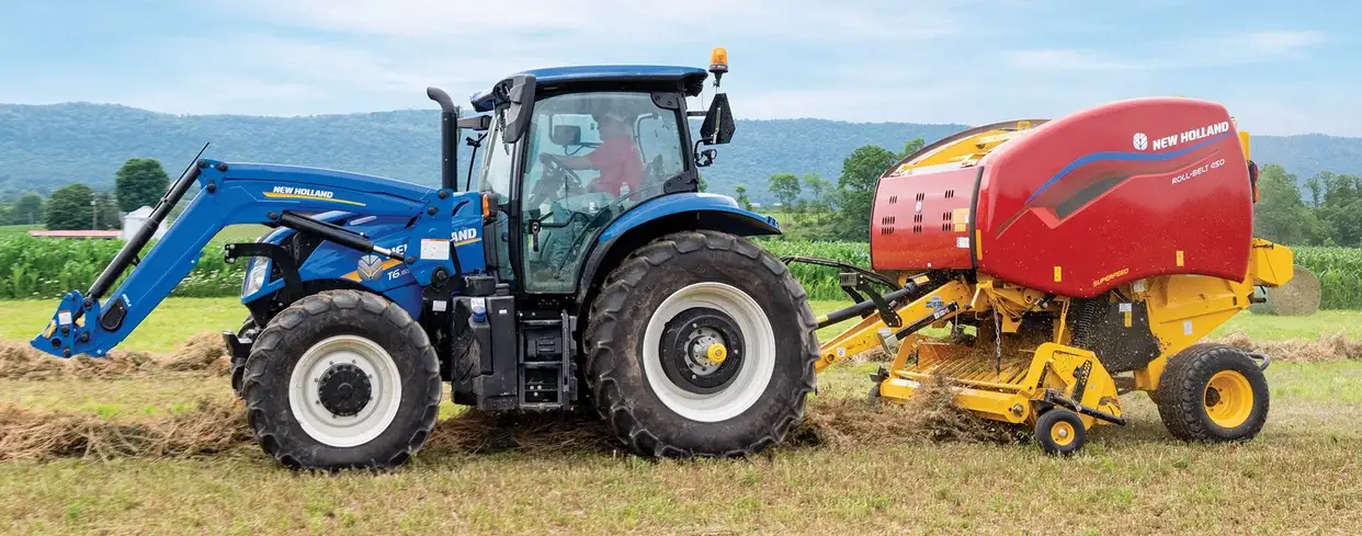Tractor pulls a Roll-Belt round baler