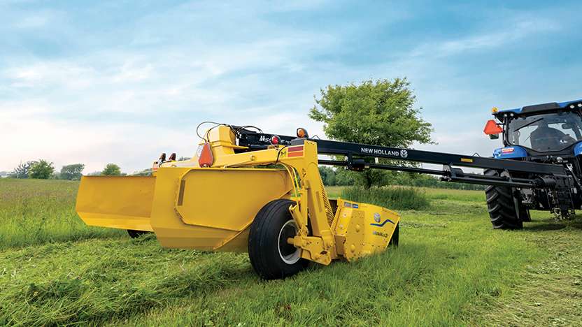 New Holland tractor pulls a Discbine disc mower-conditioner.