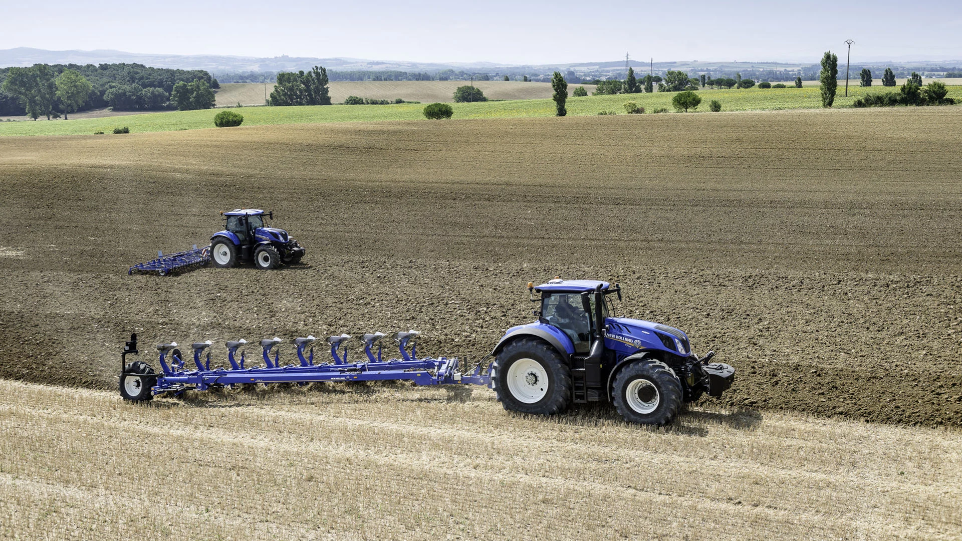 Tractor with 8 Furrow Semi-Mounted Variable Width Reversible Plough