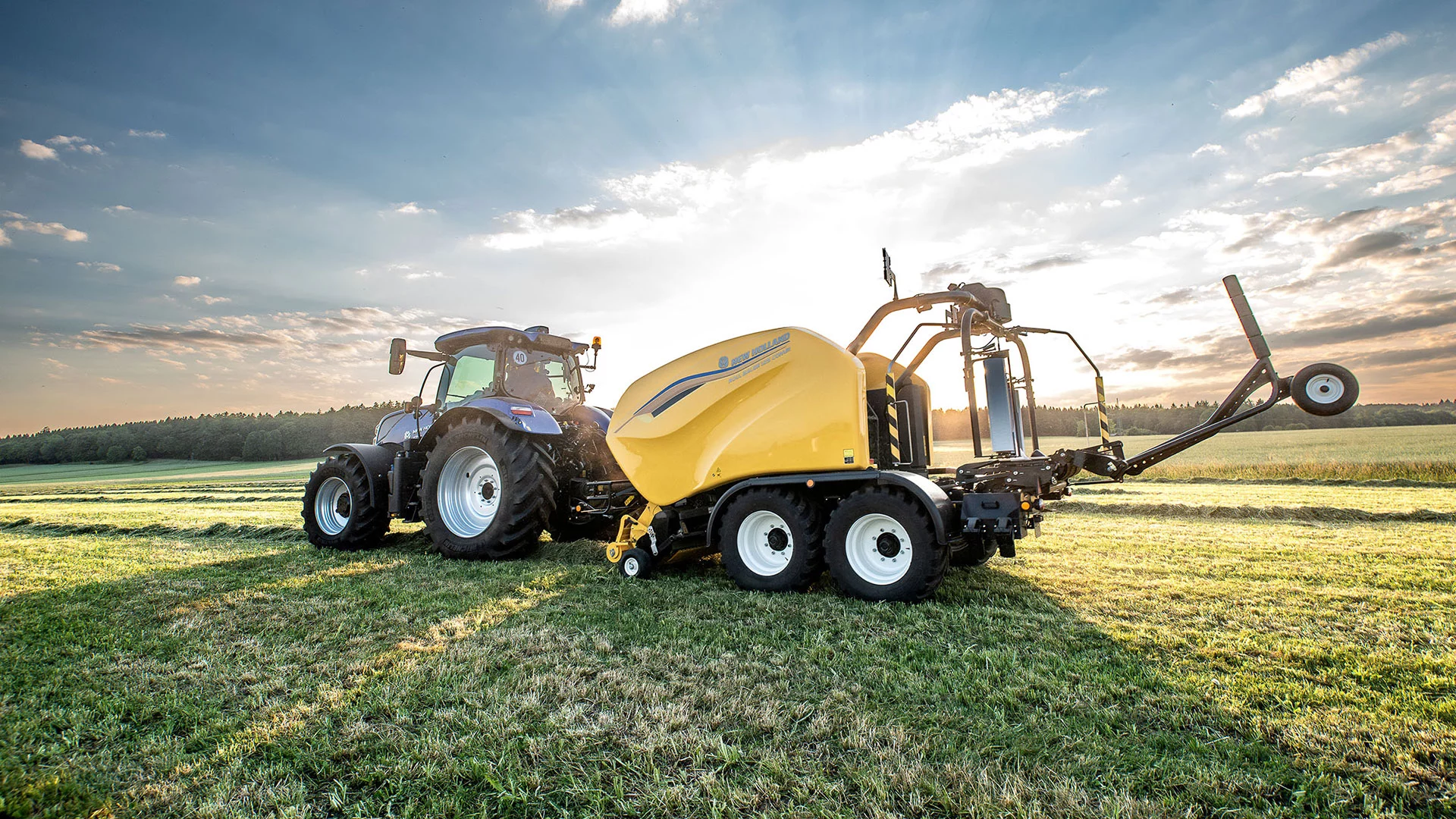 Tractor with baler on the agricultural field