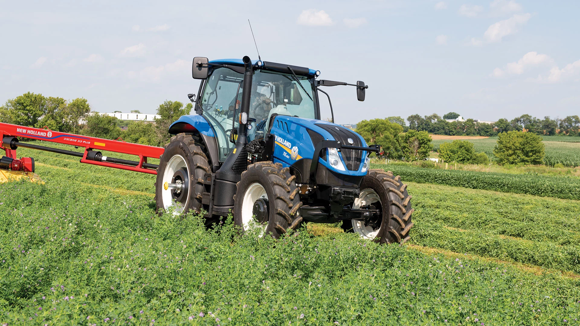 T6 Series tractor pulls a disc mower-conditioner