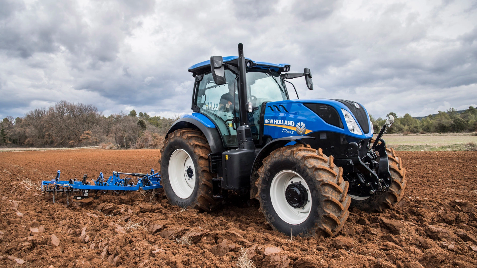 T7S  Tractor with tillage equipments working on the agricultural field