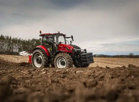 Farmall C 120 tractor working in field