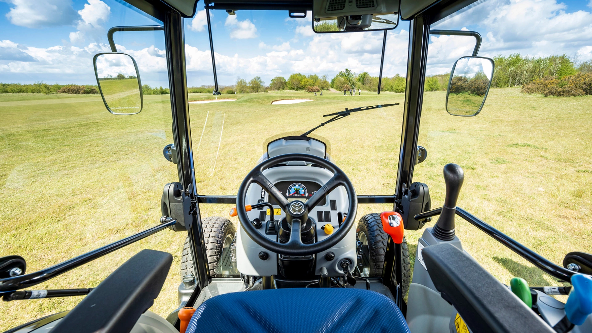 Inside the functional cabin of New Holland Boomer tractor showcasing controls