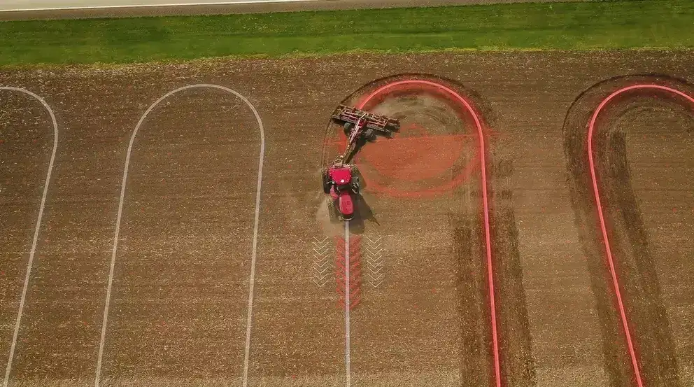 Case IH tractor pulling a tillage implement in a field with graphic lines to illustrate using AccuTurn headland turning technology.