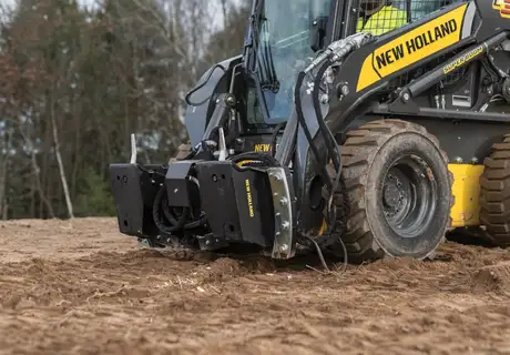 Tilt attach attached to a skid steer 