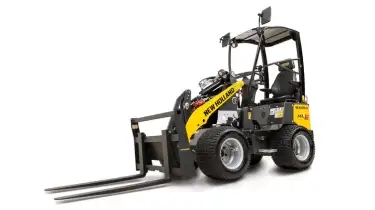 Small articulated loader with fork attachment.