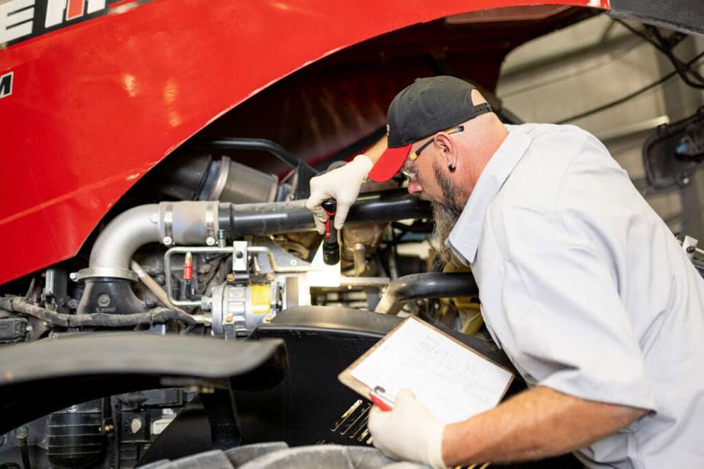 technician checking under hood