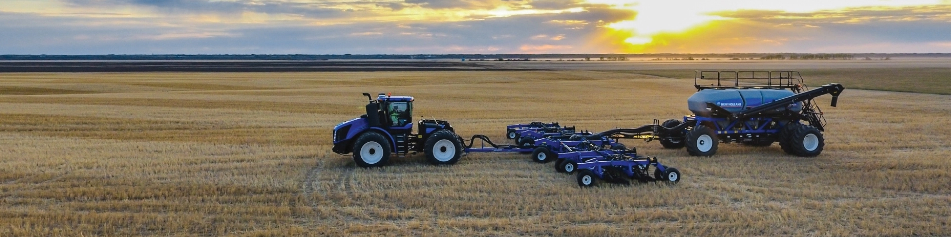 New Holland air cart and air drill attached to a tractor