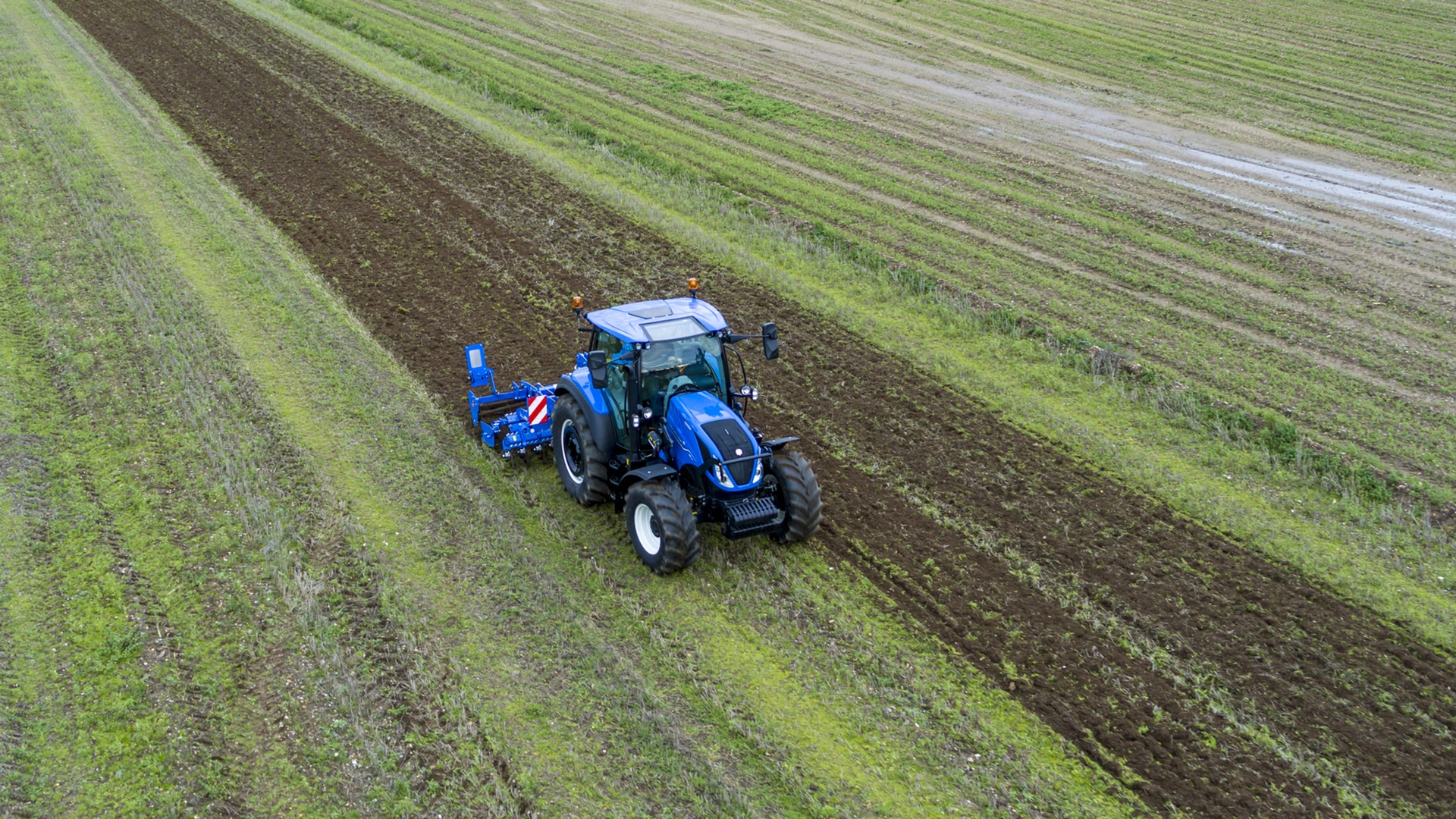 New Holland tractor employing SDM & SDH Compact Disc Cultivators for soil preparation on agricultural land