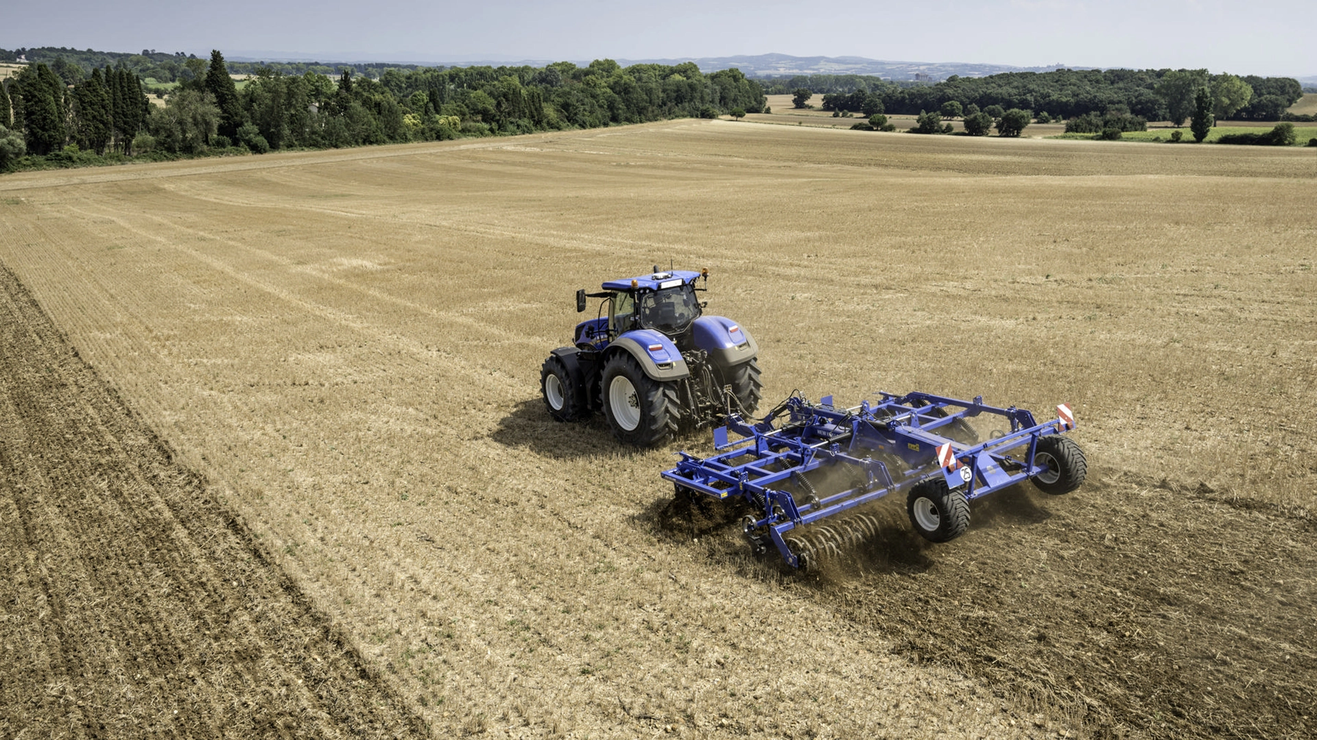 On-field operation of tractor-mounted stubble cultivator with rigid tine cultivator and rear rollers