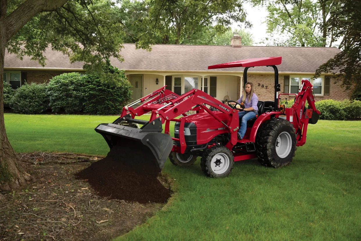 Woman operating a Farmall 25A tractor