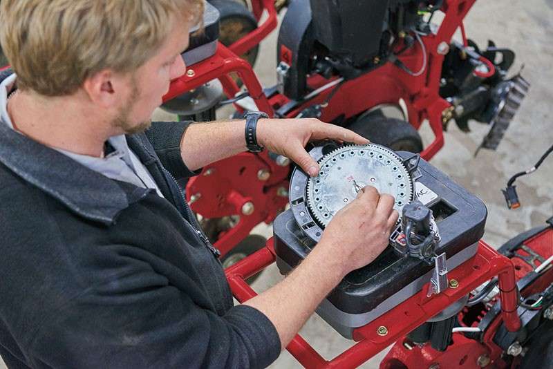 case ih technician adjusting seed meter