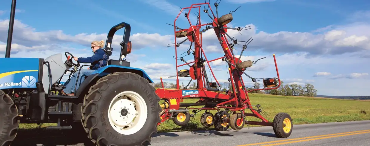 ProTed™ rotary tedder pulled behind a New Holland tractor